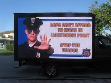 In April a truck drove around Lighthouse Point with billboards to spread awareness about the pension problems in Lighthouse Point.